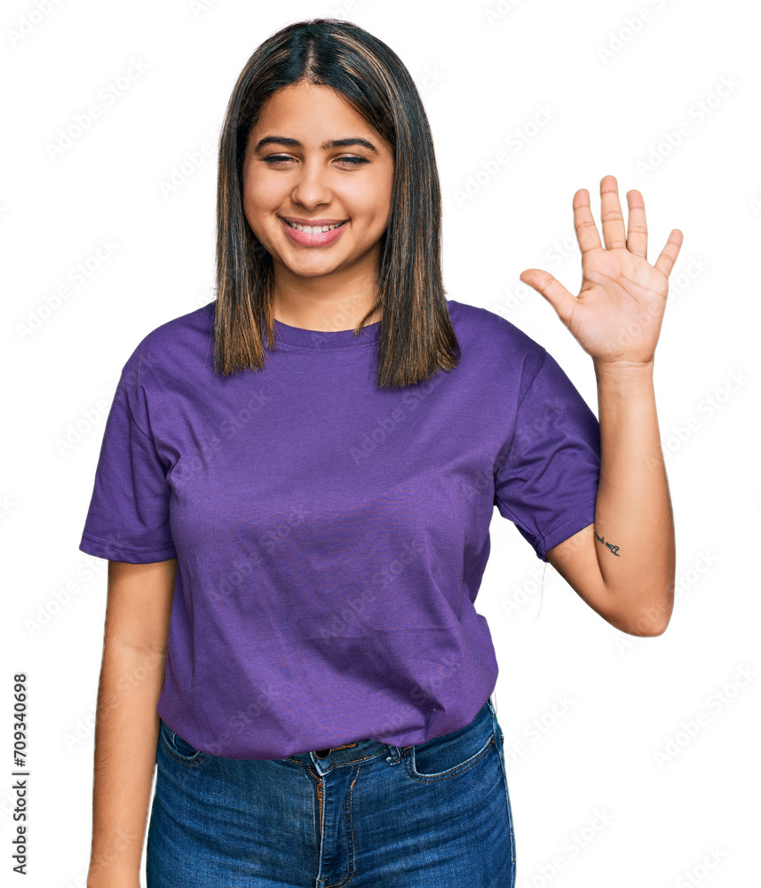 Young hispanic girl wearing casual purple t shirt showing and pointing up with fingers number five while smiling confident and happy. Young hispanic girl wearing casual purple t shirt showing and pointing up with fingers number five while smiling confident and happy.