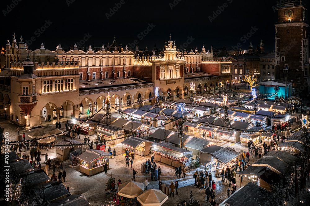 Christmas stalls with snow at night on the Main Market Square in Krakow, Poland