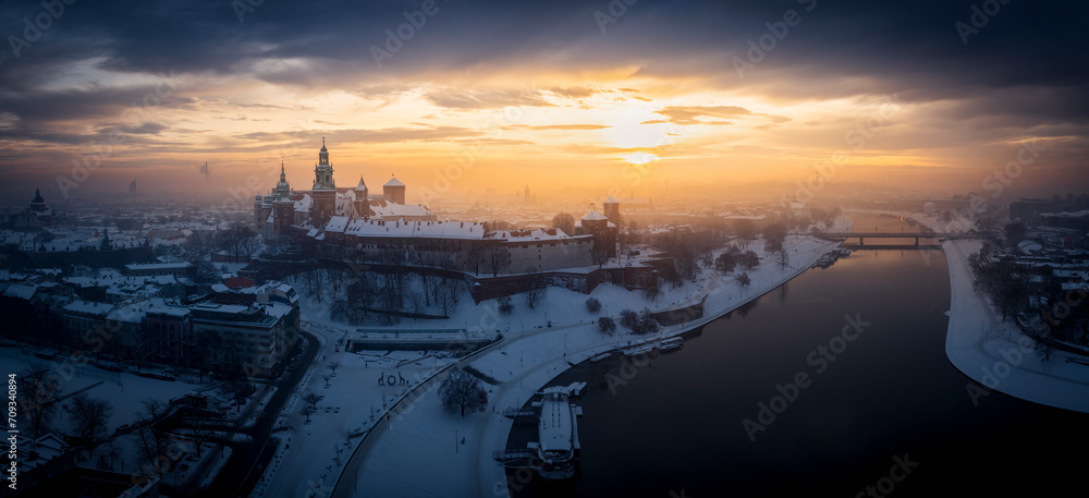 Snow-covered Wawel castle at magic morning with soft sunlight, Krakow, Poland