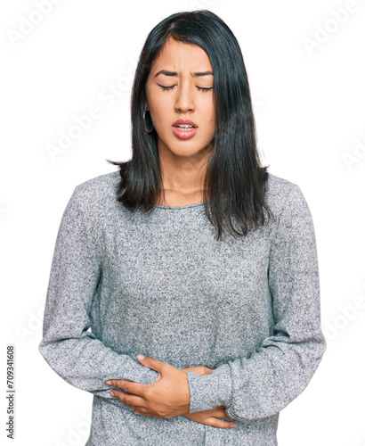 Beautiful asian young woman wearing casual clothes with hand on stomach because indigestion, painful illness feeling unwell. ache concept. © Krakenimages.com