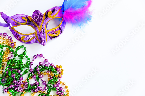 Carnival mask with feathers and colorful beads on white background. Mardi Gras or Fat Tuesday symbol.