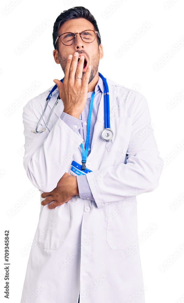 Young hispanic man wearing doctor uniform and stethoscope bored yawning tired covering mouth with hand. restless and sleepiness. Young hispanic man wearing doctor uniform and stethoscope bored yawning tired covering mouth with hand. restless and sleepiness.