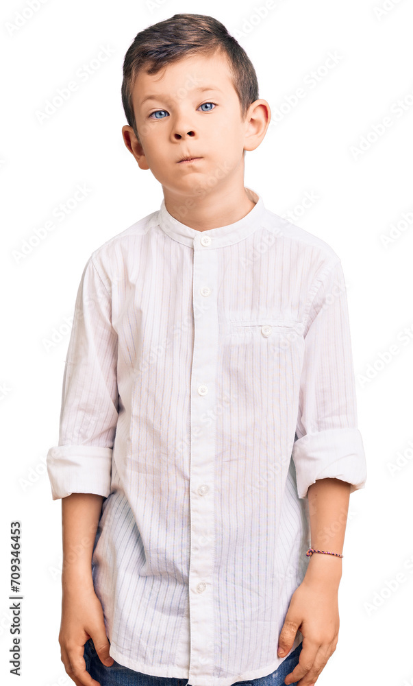 Cute blond kid wearing elegant shirt relaxed with serious expression on face. simple and natural looking at the camera. Cute blond kid wearing elegant shirt relaxed with serious expression on face. simple and natural looking at the camera.