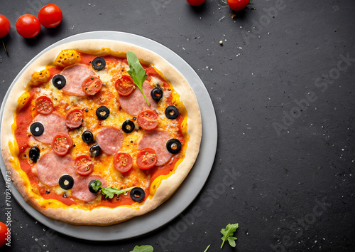pizza on a plate black table background