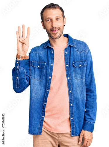 Young handsome man wearing casual clothes showing and pointing up with fingers number four while smiling confident and happy.