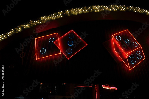 Photography Colorful neon advertises gambling opportunities in Las Vegas with dice rolling across a sign