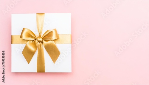 blank gift card with golden bow on pink background top view space for text © Faith