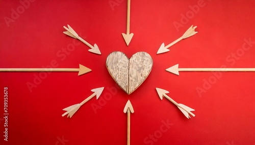 natural wooden heart shape is targeted by arrows on bold red background minimal ready for romance concept with copy space flat lay cupidon love idea valentines day holiday photo