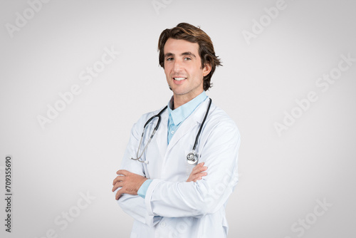 Confident european male doctor with arms crossed smiling