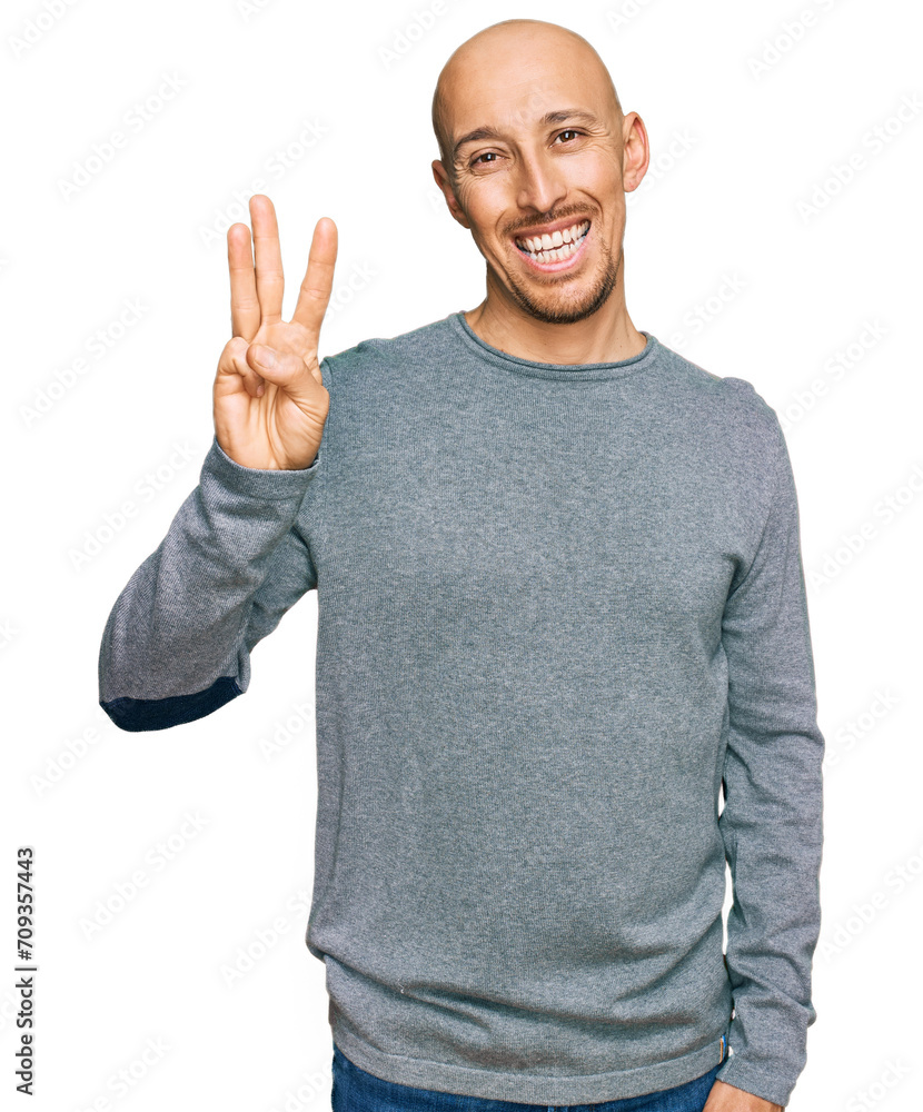 Bald man with beard wearing casual clothes showing and pointing up with fingers number three while smiling confident and happy. Bald man with beard wearing casual clothes showing and pointing up with fingers number three while smiling confident and happy.
