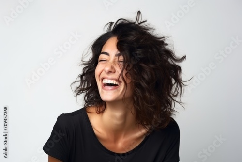 Portrait of a beautiful woman laughing with her hair in the wind