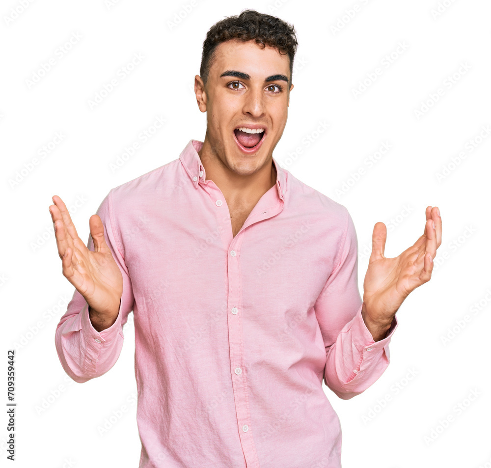 Fototapeta premium Hispanic young man wearing casual clothes celebrating victory with happy smile and winner expression with raised hands
