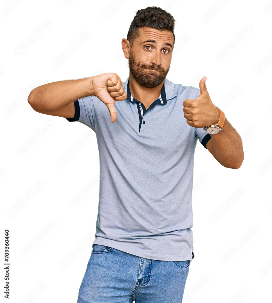 Handsome man with beard wearing casual clothes doing thumbs up and down, disagreement and agreement expression. crazy conflict Handsome man with beard wearing casual clothes doing thumbs up and down, disagreement and agreement expression. crazy conflict