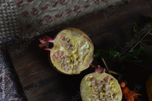 fresh pomegranate on rustic wooden board with copy space photo