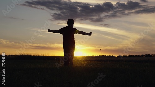 Child Dream flight to future. Teenager dreams of flying becoming pilot. Aviator kid runs with toy plane across field in rays of sunset. Boy child become an astronaut pilot. Kid play with toy plane