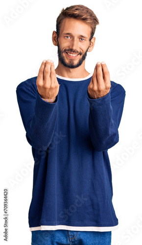 Handsome blond man with beard wearing casual sweater doing money gesture with hands, asking for salary payment, millionaire business