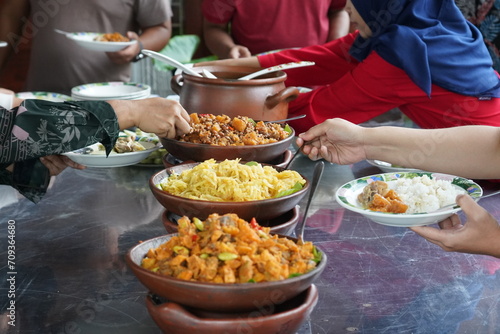 Various kinds of menus are served in buffet manner which is usually at a meeting, party, wedding or family gathering. Traditional culinary like chicken, fish, tempeh, tofu, potato, vegetable and egg. photo