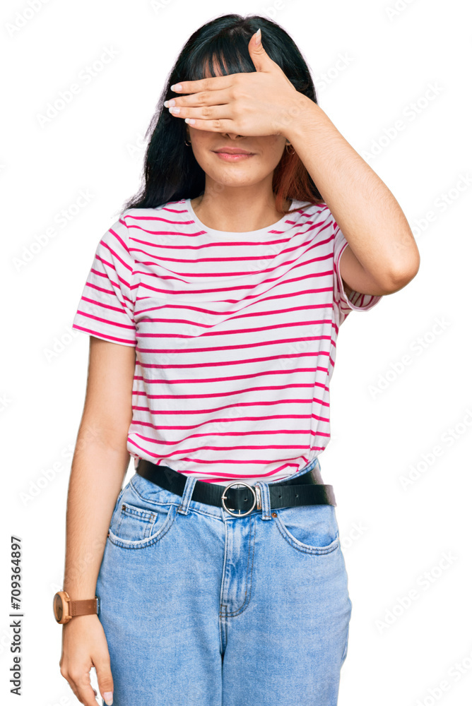 Young hispanic girl wearing casual clothes covering eyes with hand, looking serious and sad. sightless, hiding and rejection concept Young hispanic girl wearing casual clothes covering eyes with hand, looking serious and sad. sightless, hiding and rejection concept