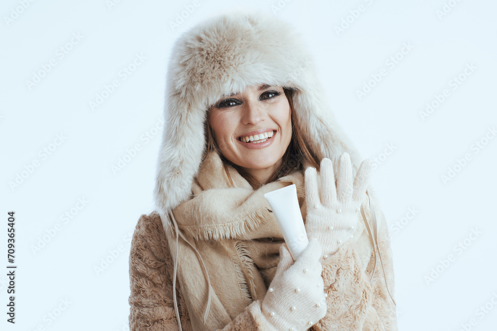 happy stylish woman in winter coat and fur hat on white happy stylish woman in winter coat and fur hat on white