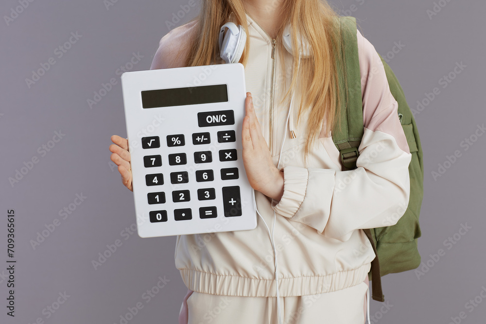 Closeup on school girl in beige tracksuit with backpack Closeup on school girl in beige tracksuit with backpack