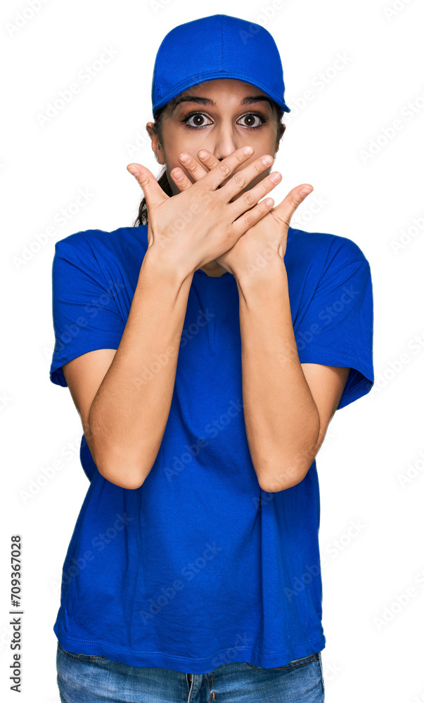 Young hispanic girl wearing delivery courier uniform shocked covering mouth with hands for mistake. secret concept. Young hispanic girl wearing delivery courier uniform shocked covering mouth with hands for mistake. secret concept.