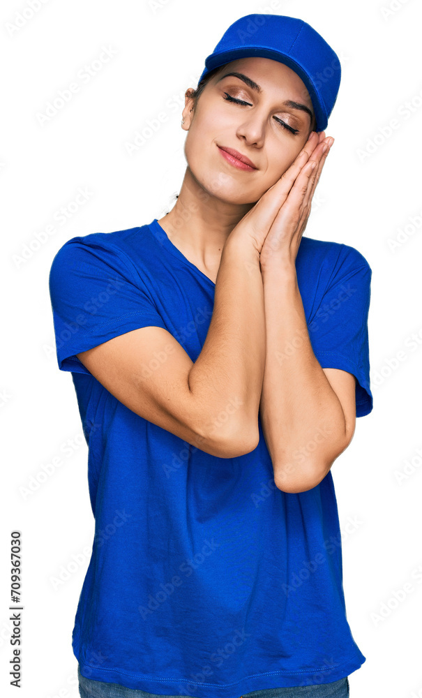 Young hispanic girl wearing delivery courier uniform sleeping tired dreaming and posing with hands together while smiling with closed eyes. Young hispanic girl wearing delivery courier uniform sleeping tired dreaming and posing with hands together while smiling with closed eyes.