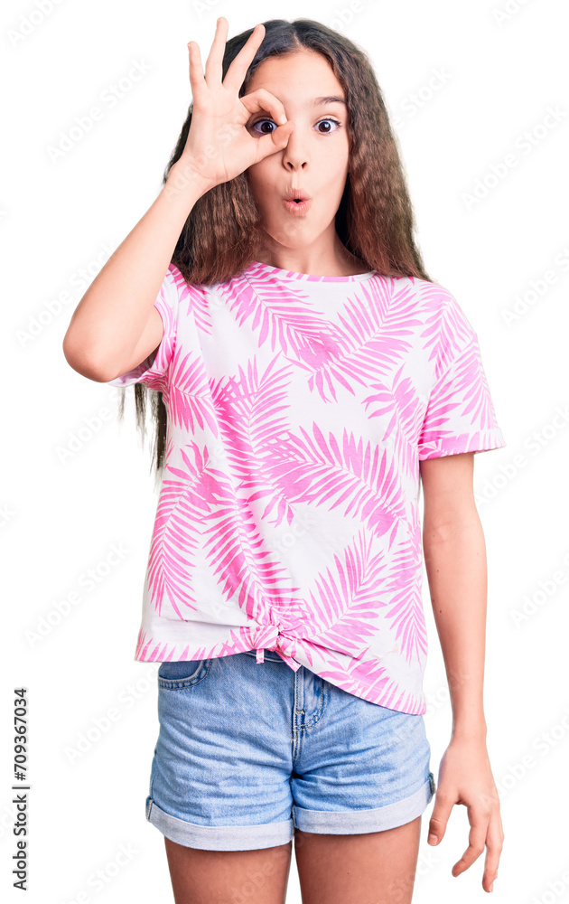 Cute hispanic child girl wearing casual clothes doing ok gesture shocked with surprised face, eye looking through fingers. unbelieving expression. Cute hispanic child girl wearing casual clothes doing ok gesture shocked with surprised face, eye looking through fingers. unbelieving expression.
