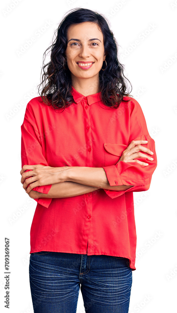 Young beautiful hispanic woman wearing casual clothes happy face smiling with crossed arms looking at the camera. positive person. Young beautiful hispanic woman wearing casual clothes happy face smiling with crossed arms looking at the camera. positive person.