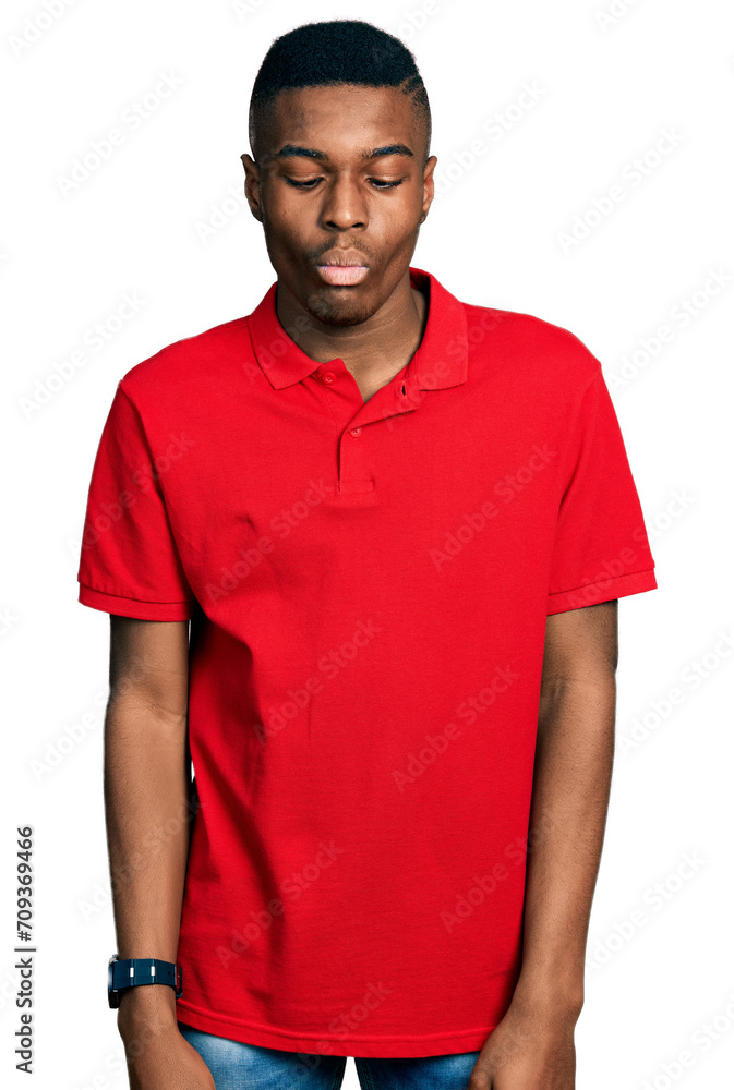 Young african american man wearing casual red t shirt making fish face with lips, crazy and comical gesture. funny expression. Young african american man wearing casual red t shirt making fish face with lips, crazy and comical gesture. funny expression.