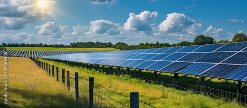 England's expansive solar panel farm, enclosed by fences, in rural fields.