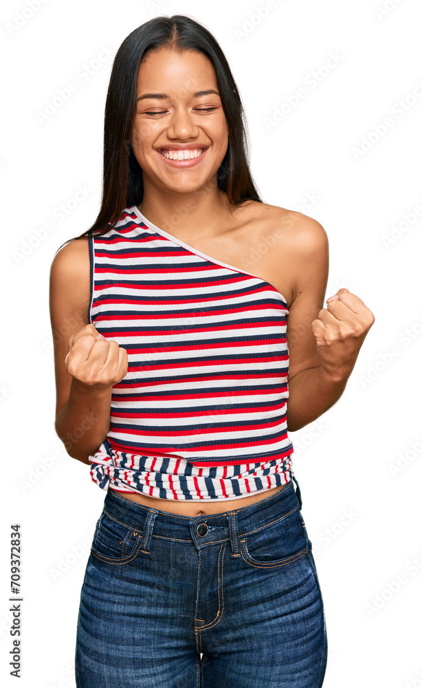 Obraz premium Beautiful hispanic woman wearing casual clothes excited for success with arms raised and eyes closed celebrating victory smiling. winner concept.