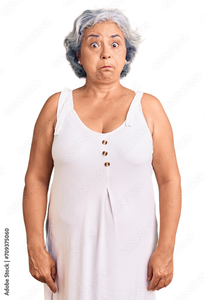 Senior woman with gray hair wearing casual clothes puffing cheeks with funny face. mouth inflated with air, crazy expression. Senior woman with gray hair wearing casual clothes puffing cheeks with funny face. mouth inflated with air, crazy expression.