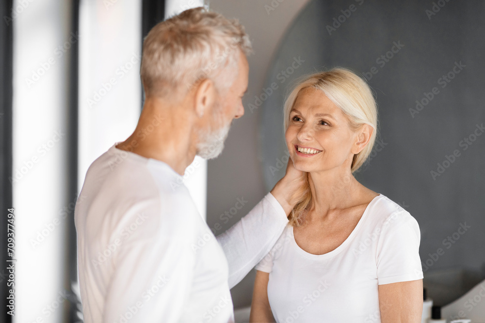 Romantic elderly couple sharing tender moment in bathroom Romantic elderly couple sharing tender moment in bathroom