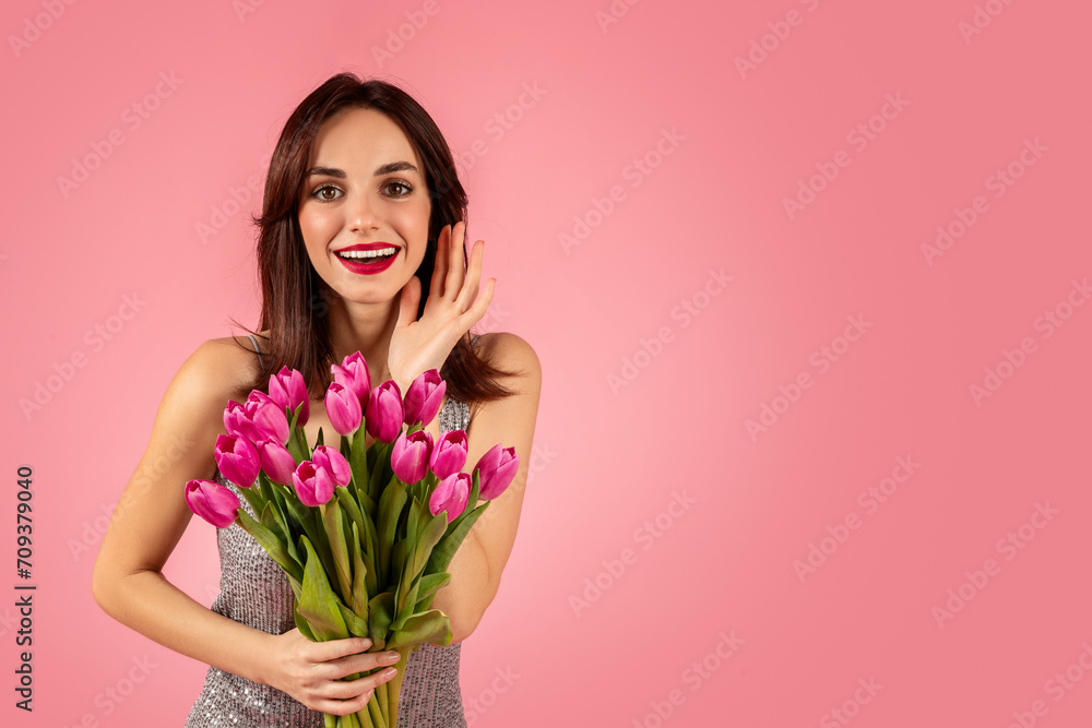 Vibrant young woman in a sparkling dress, cheerfully holding a bouquet Vibrant young woman in a sparkling dress, cheerfully holding a bouquet