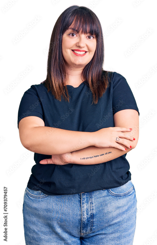 Young plus size woman wearing casual clothes happy face smiling with crossed arms looking at the camera. positive person. Young plus size woman wearing casual clothes happy face smiling with crossed arms looking at the camera. positive person.