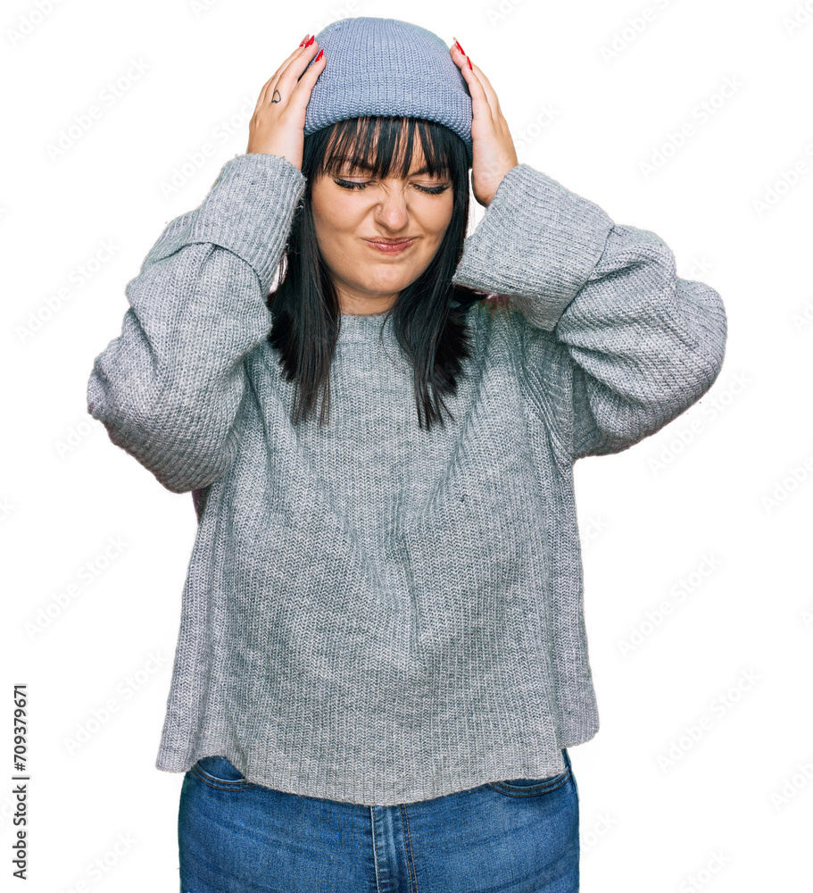 Young hispanic woman wearing cute wool cap suffering from headache desperate and stressed because pain and migraine. hands on head. Young hispanic woman wearing cute wool cap suffering from headache desperate and stressed because pain and migraine. hands on head.