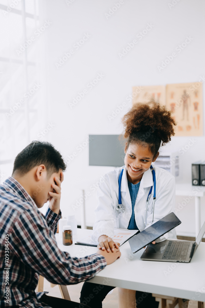 Fototapeta premium The African doctor holds the patient’s. hand Healthcare and medical concept. In hospital..