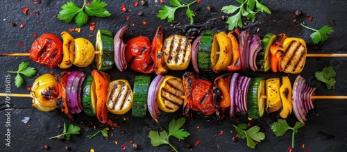 Top view of assorted grilled vegetable vegan skewers. photo