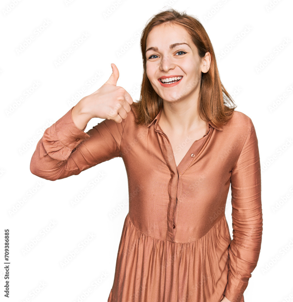 Young caucasian woman wearing sexy party dress smiling happy and positive, thumb up doing excellent and approval sign Young caucasian woman wearing sexy party dress smiling happy and positive, thumb up doing excellent and approval sign