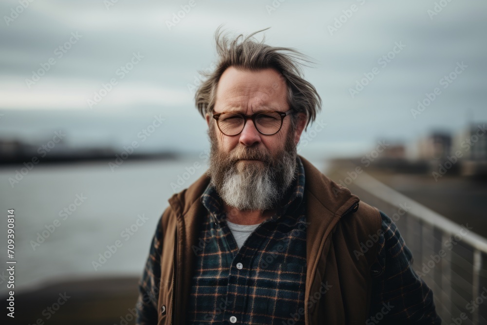 Portrait of a handsome senior man with long gray hair and beard wearing casual clothes outdoors Portrait of a handsome senior man with long gray hair and beard wearing casual clothes outdoors