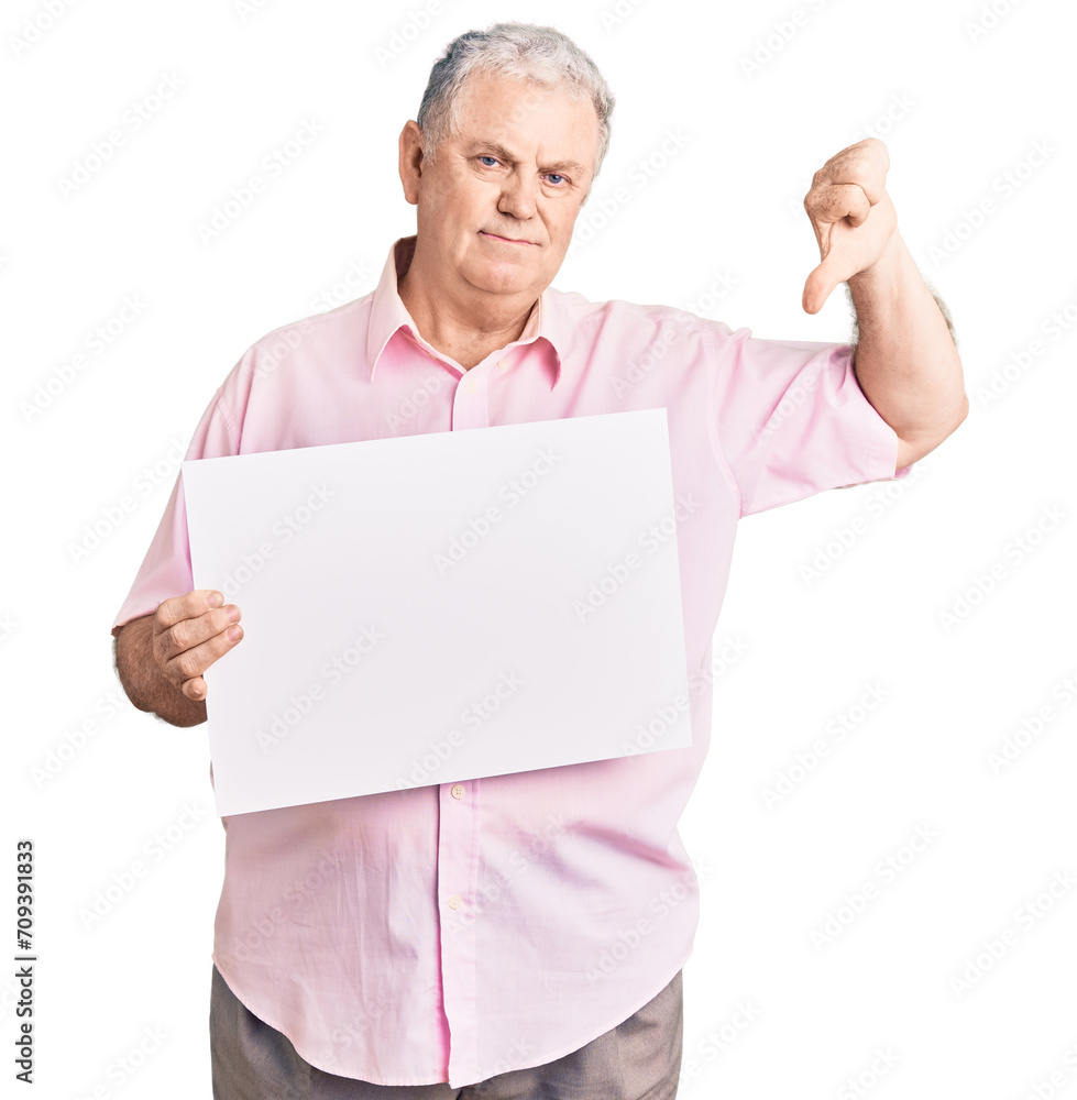 Senior grey-haired man holding blank empty banner with angry face, negative sign showing dislike with thumbs down, rejection concept Senior grey-haired man holding blank empty banner with angry face, negative sign showing dislike with thumbs down, rejection concept