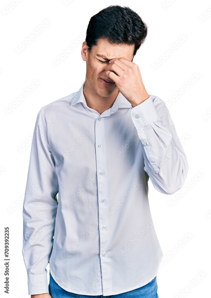 Young hispanic business man wearing business clothes tired rubbing nose and eyes feeling fatigue and headache. stress and frustration concept. Young hispanic business man wearing business clothes tired rubbing nose and eyes feeling fatigue and headache. stress and frustration concept.