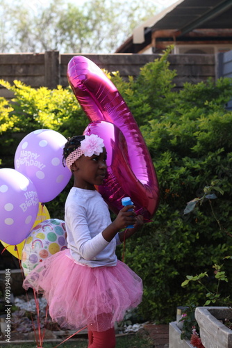 Young African Child celebrating birthday with baloons © Shona