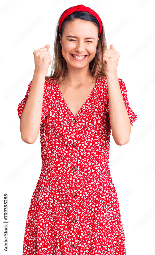 Young beautiful girl wearing dress and diadem excited for success with arms raised and eyes closed celebrating victory smiling. winner concept. Young beautiful girl wearing dress and diadem excited for success with arms raised and eyes closed celebrating victory smiling. winner concept.