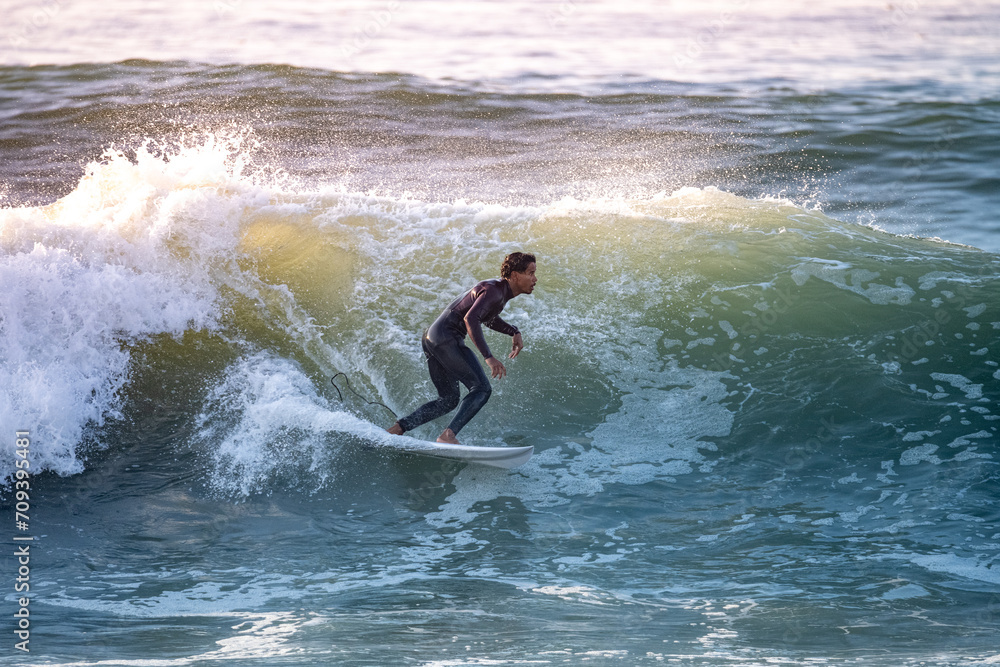 Brave teenager making tricks on the rough sea Brave teenager making tricks on the rough sea
