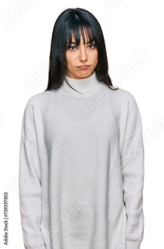 Young brunette woman with bangs wearing casual turtleneck sweater depressed and worry for distress, crying angry and afraid. sad expression.