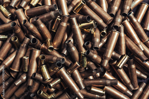 Photo of a pile of copper colored bullet shells texture or pattern.
