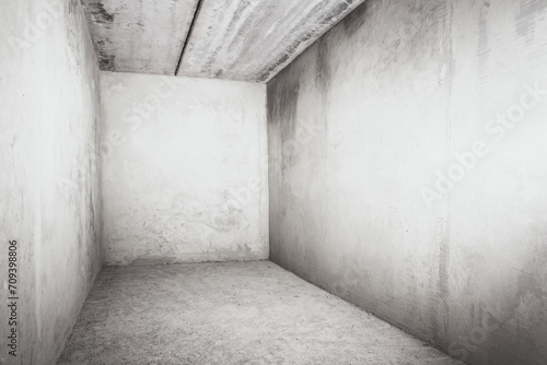 Photo of an empty room under construction with concrete walls and a ceiling. House building concept.