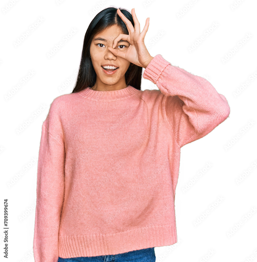 Beautiful young asian woman wearing casual winter sweater doing ok gesture with hand smiling, eye looking through fingers with happy face. Beautiful young asian woman wearing casual winter sweater doing ok gesture with hand smiling, eye looking through fingers with happy face.