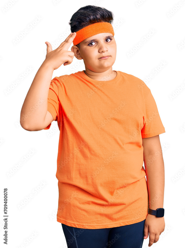 Little boy kid wearing sportswear shooting and killing oneself pointing hand and fingers to head like gun, suicide gesture. Little boy kid wearing sportswear shooting and killing oneself pointing hand and fingers to head like gun, suicide gesture.
